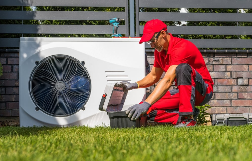 A fully trained technician repairing an hvac system - Authentic Air's Frequently Asked Questions