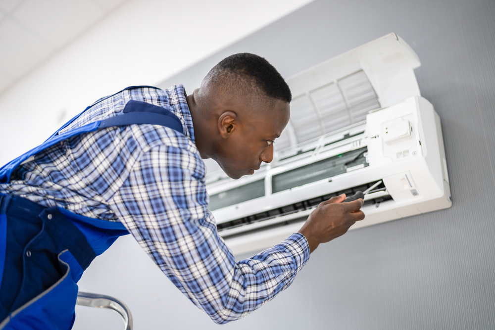 Technician repairing hvac system in new orleans - Why New Orleans Trusts Authentic Air for HVAC Needs