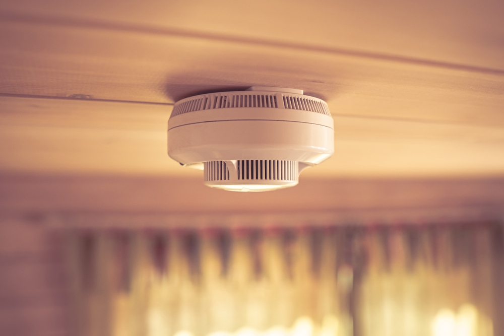 Smoke and carbon monoxide detectors in a wooden house in New Orleans, essential for winter safety.