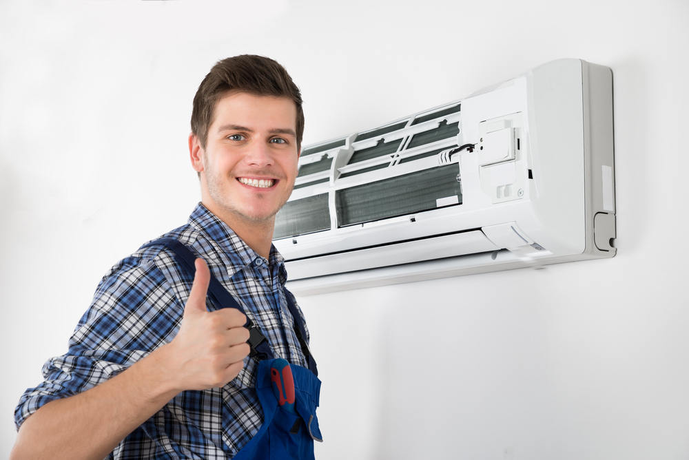 Young, Satisfied HVAC Technician Giving a Thumbs Up After Successful Air Conditioning Repair