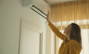A woman in New Orleans checks the HVAC system in her apartment for optimal performance.